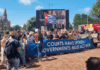 A West Papuan Morning Star flag of independence flies higm among dozens of climate activists - from both the Netherlands and abroad - gathered on a square outside the court