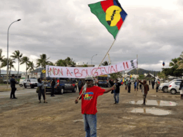 FLNKS (Kanak and Socialist National Liberation Front) members hold "No to Bougival" banners in a Nouméa protest