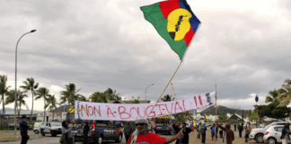 FLNKS (Kanak and Socialist National Liberation Front) members hold "No to Bougival" banners in a Nouméa protest