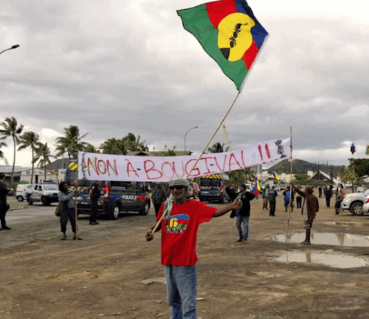 FLNKS (Kanak and Socialist National Liberation Front) members hold "No to Bougival" banners in a Nouméa protest