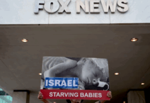Protesters hold aloft an image of a baby dying from starvation outside the Washington headquarters of Fox News