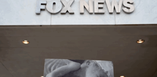Protesters hold aloft an image of a baby dying from starvation outside the Washington headquarters of Fox News
