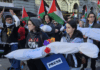 New Zealand pro-Palestine protesters in Auckland carry mock "bodies" today representing Gazan journalists killed by the Israeli military