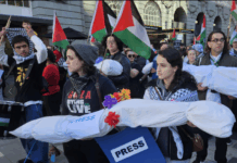 New Zealand pro-Palestine protesters in Auckland carry mock "bodies" today representing Gazan journalists killed by the Israeli military