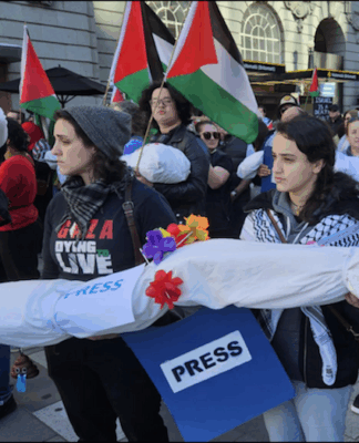 New Zealand pro-Palestine protesters in Auckland carry mock "bodies" today representing Gazan journalists killed by the Israeli military