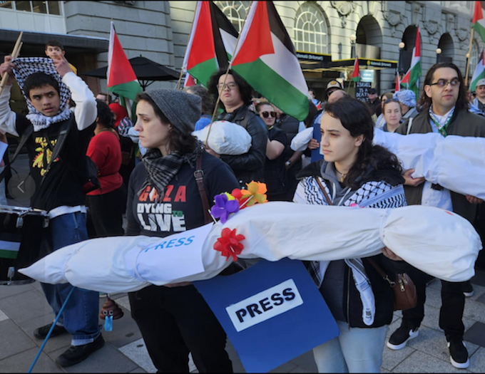 Journos bodies march DR 680wide New Zealand pro-Palestine protesters in Auckland carry mock