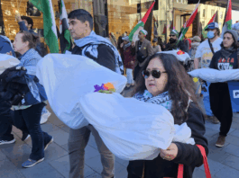 New Zealand protesters carry symbolic "bodies" of Palestinian journalists slaughtered by the Israeli military