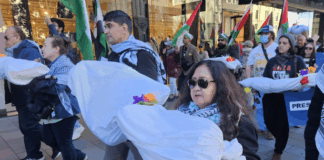 New Zealand protesters carry symbolic "bodies" of Palestinian journalists slaughtered by the Israeli military