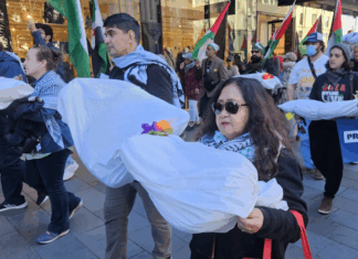New Zealand protesters carry symbolic "bodies" of Palestinian journalists slaughtered by the Israeli military