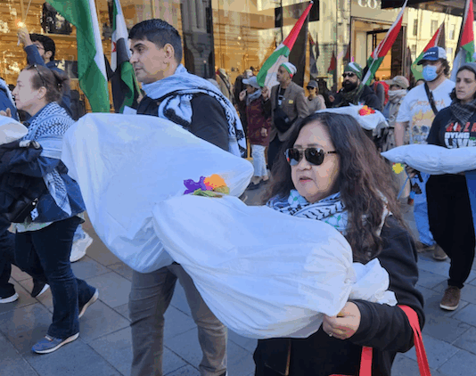 New Zealand protesters carry symbolic "bodies" of Palestinian journalists slaughtered by the Israeli military