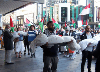 New Zealand protesters over the Israeli killings of Palestinian journalists in Gaza carry symbolic bodies