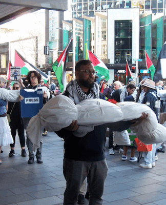 New Zealand protesters over the Israeli killings of Palestinian journalists in Gaza carry symbolic bodies