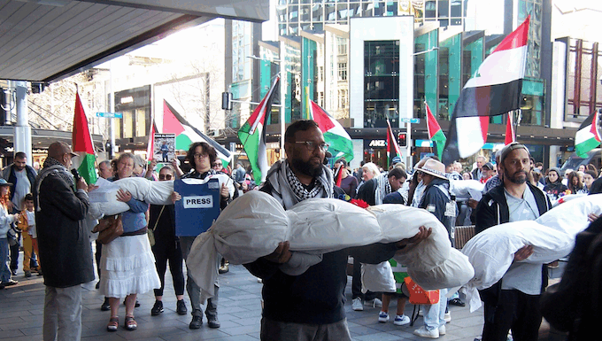 New Zealand protesters over the Israeli killings of Palestinian journalists in Gaza carry symbolic bodies