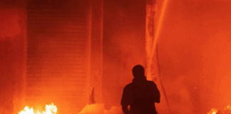 Marshall Islands firefighters try to contain the Nitijela (Parliament) fire