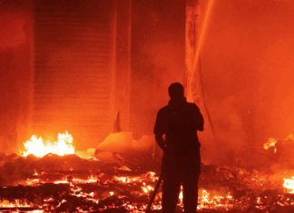 Marshall Islands firefighters try to contain the Nitijela (Parliament) fire