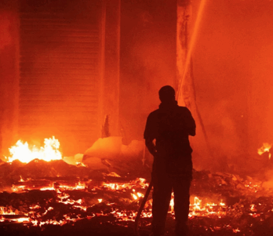 Marshall Islands firefighters try to contain the Nitijela (Parliament) fire