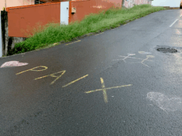 The word "peace" in French is scrawled on the road between Nouméa and Magenta beach