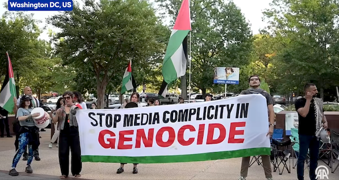 "Stop media complicity in genocide" says the protest banner