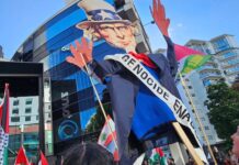An Uncle Sam puppet with blood on his hands held aloft by pro-Palestinian protesters in Auckland, New Zealand