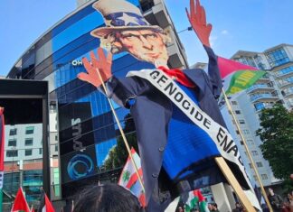 An Uncle Sam puppet with blood on his hands held aloft by pro-Palestinian protesters in Auckland, New Zealand