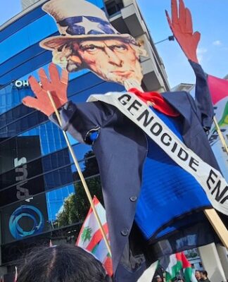 An Uncle Sam puppet with blood on his hands held aloft by pro-Palestinian protesters in Auckland, New Zealand