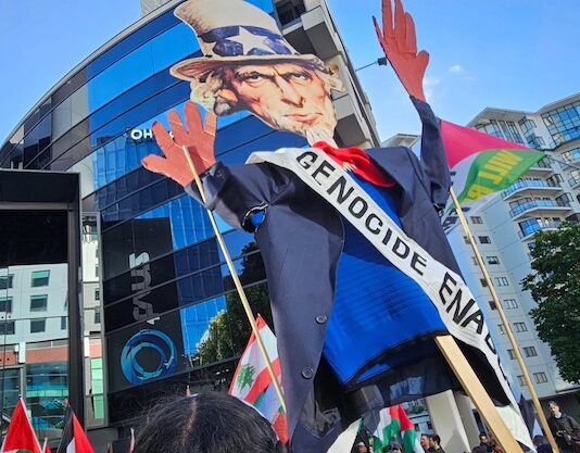 An Uncle Sam puppet with blood on his hands held aloft by pro-Palestinian protesters in Auckland, New Zealand