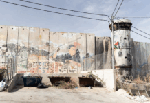 Israel's "apartheid wall" looms high above Aida refugee camp, up to nine metres tall in some places