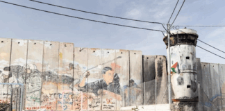 Israel's "apartheid wall" looms high above Aida refugee camp, up to nine metres tall in some places