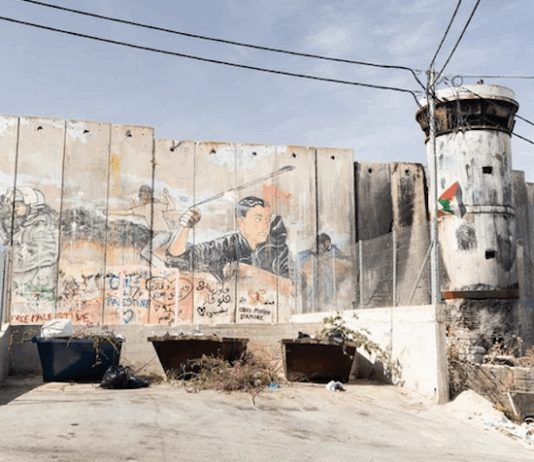 Israel's "apartheid wall" looms high above Aida refugee camp, up to nine metres tall in some places