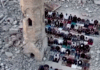 Palestinians perform prayer next to the rubble of a mosque that was destroyed by the Israeli occupation forces during the Gaza genocide