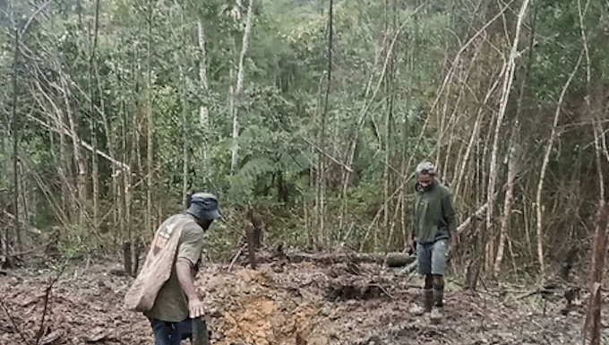 Kiwirok villagers show some of the areas that have been bombed in the attack on their village
