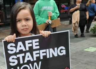 NZ health minister unethical over medical ethics – ‘look in the mirror’ A child holds a medical "safe staffing" placard at the mega strike in Auckland