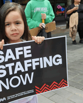 NZ health minister unethical over medical ethics – ‘look in the mirror’ A child holds a medical "safe staffing" placard at the mega strike in Auckland
