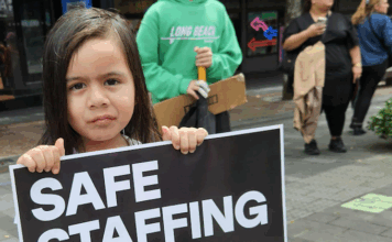 NZ health minister unethical over medical ethics – ‘look in the mirror’ A child holds a medical "safe staffing" placard at the mega strike in Auckland