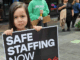 NZ health minister unethical over medical ethics – ‘look in the mirror’ A child holds a medical "safe staffing" placard at the mega strike in Auckland