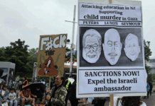 New Zealand protesters hold a placard calling for sanctions against Israel