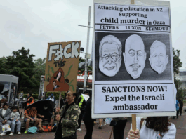 New Zealand protesters hold a placard calling for sanctions against Israel