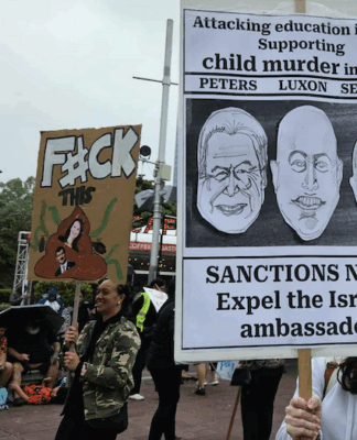 New Zealand protesters hold a placard calling for sanctions against Israel