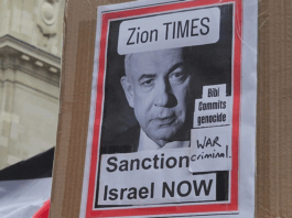 "War criminal" . . . a poster condemning Israeli Prime Minister Benjamin Netanyahu