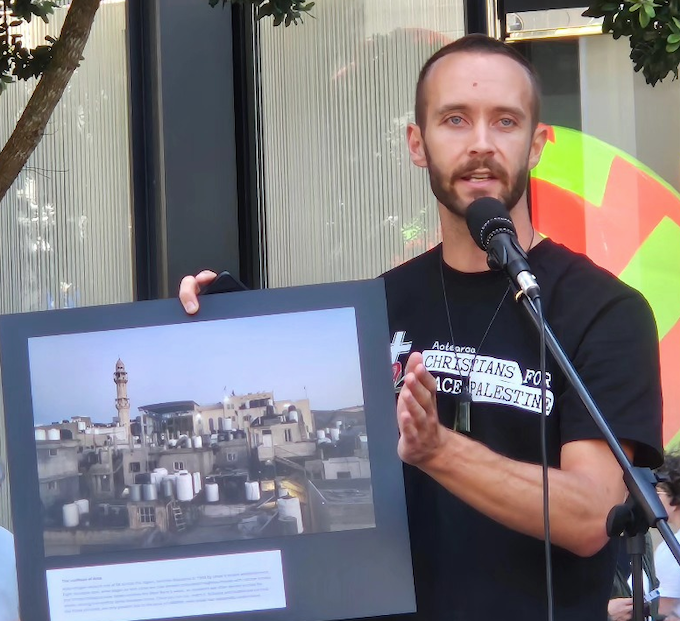 Journalist Cole Martin speaking at the UN Solidarity Day rally in Auckland today about his experiences bearing witness in the occupied West Bank