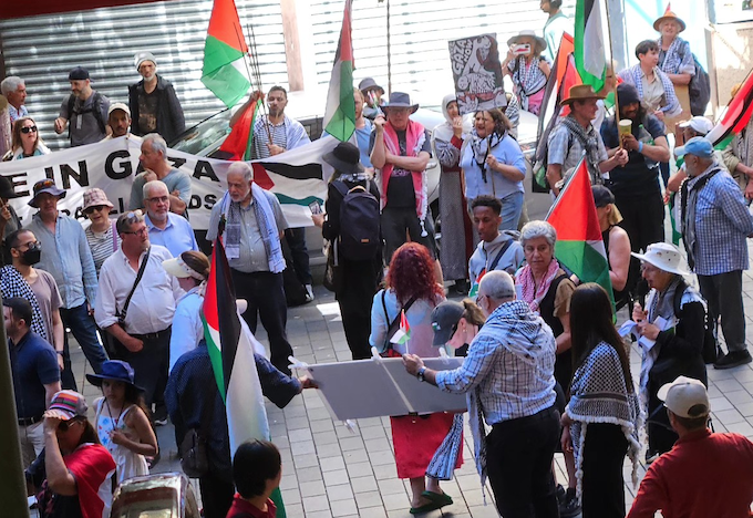 Pro-Palestinian protesters outside the Elliott Street entrance to The Warehouse in Auckland