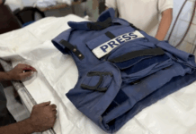 Relatives mourn over the body of Palestinian journalist Ahmad Abu Mutayr