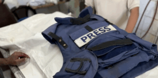 Relatives mourn over the body of Palestinian journalist Ahmad Abu Mutayr