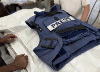 Relatives mourn over the body of Palestinian journalist Ahmad Abu Mutayr