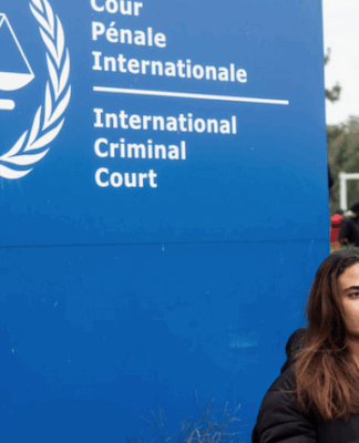 A demonstrator holds a sign reading, "Selective Justice is Injustice"