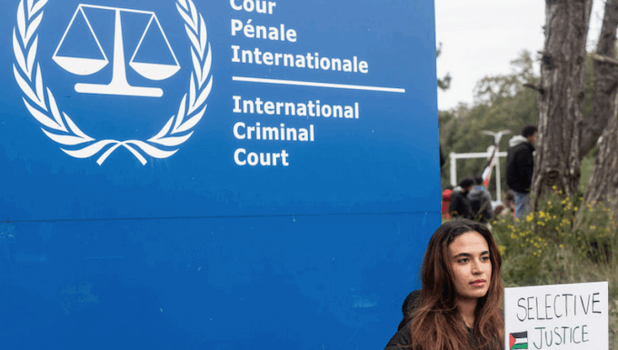 How Israel has set a dangerous precedent in international law A demonstrator holds a sign reading, "Selective Justice is Injustice"