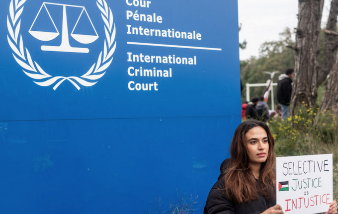 ICC selective justice ICC 680wide A demonstrator holds a sign reading,