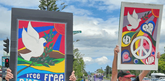 "Let Gaza Live" says a placard in a New Zealand protest against the Israeli genocide and environmental devastation in West Auckland
