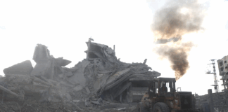 Palestinians clear rubble to search for survivors in a Gaza house