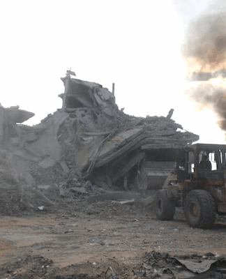 Palestinians clear rubble to search for survivors in a Gaza house
